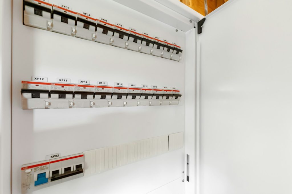 Geopende verdeelkast met gelabelde installatieautomaten in twee rijen